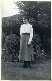 Images Dated 30th April 2020: A female student (?) posing for a photograph in a suburban garden. circa 1910s