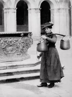 Female water carrier at a well, Venice, Italy