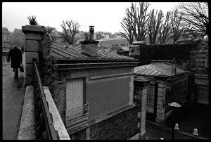 Figure walking outside Paris cemetery, France