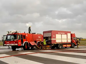 Fire crews attend the aftermath of a plane crash