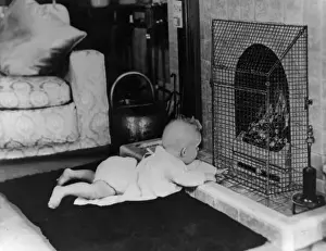 Curiosity Prints: Fire safety -- baby playing near guarded coal fire