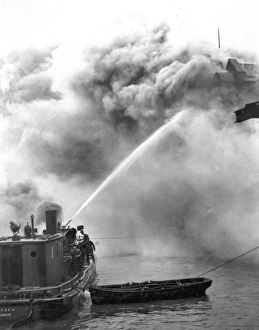 Images Dated 11th October 2011: A fireboat tackling a blaze on the River Thames