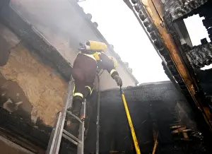 Firefighter in breathing apparatus working at fire