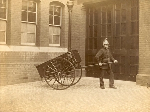 Images Dated 9th November 2011: A firefighter of the London Fire Brigade pulling a cart