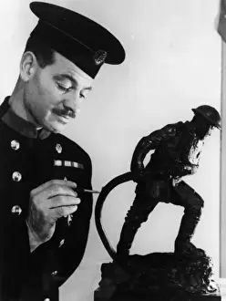 Statuette Prints: Firefighter painting statuette of fireman in action