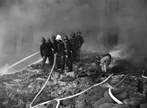 Firefighters in action with hosepipes, Poplar, East London