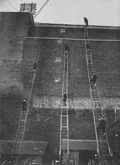 Firefighters climbing wheeled escape ladders