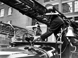 Adjusting Gallery: Two firefighters with fire engine