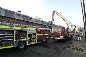 Firefighters in a hydraulic lift at a fire on West Road