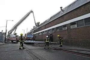 Firefighters in a hydraulic lift at a fire on West Road