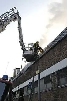 Firefighters in a hydraulic lift at a fire on West Road