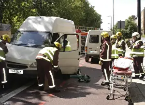 Firefighters inspecting a broken down Ford transit van