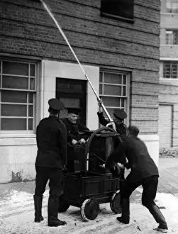 Firefighters operating old pump at special drill display
