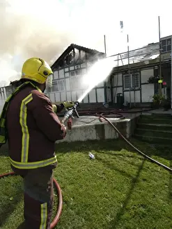 Reflective Prints: Firefighters respond to a building fire, West London