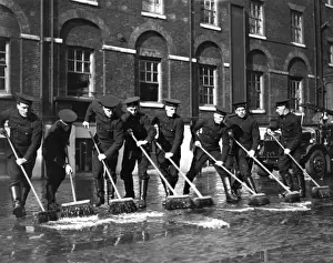 Firefighters with sweeping brushes, Southwark HQ