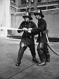 Drills Prints: Firefighters taking part in a hose training drill