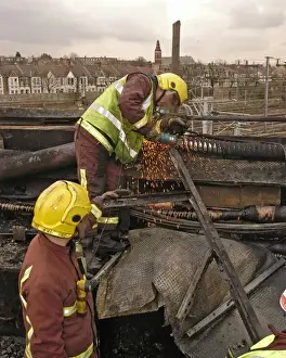 Firefighters using cutting equipment, West London