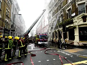 Firefighters using turntable ladder