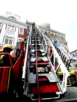 Firefighters using turntable ladder
