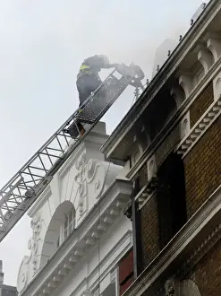 Firefighters using turntable ladder