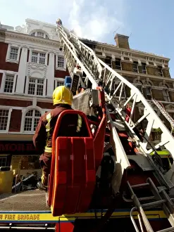 Firefighters using turntable ladder