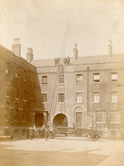 Images Dated 28th November 2011: Firefighters using a wheeled ladder escape