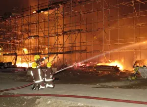 Firefighters working at fire on building site