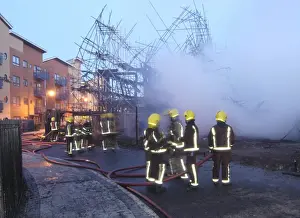 Firefighters working at fire on building site