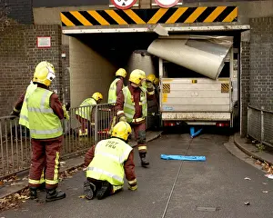 Firefighters working to remove van trapped under bridge