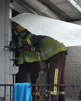 Firefighters working to remove van trapped under bridge