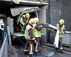 Firefighters working to remove van trapped under bridge