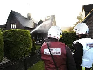 Firefighters working at scene of domestic fire, Harrow