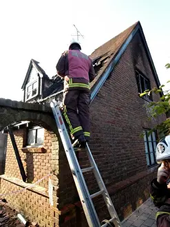 Firefighters working at scene of domestic fire, Harrow