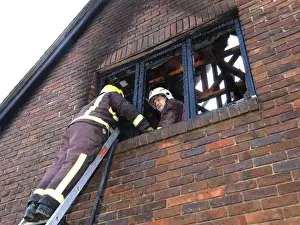 Firefighters working at scene of domestic fire, Harrow