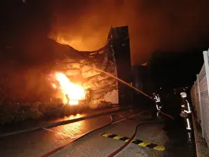 Firefighters working at scene of large warehouse fire