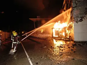 Firefighters working at scene of large warehouse fire