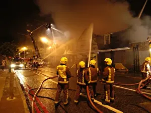 Firefighters working at scene of pub fire, SE London