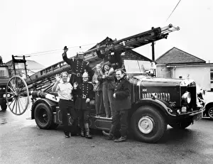 Firemen and children with 1927 Dennis fire engine