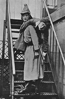 Firewomen, a rescue on an iron staircase, WW1