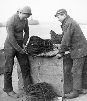Baiting Collection: Fisherman baiting lines early 1900s