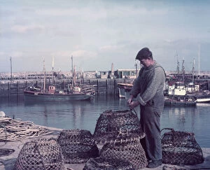 Brixham Gallery: Fisherman with lobster pots, Brixham Harbour, Devon