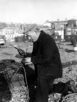 Fisherman mending nets at Hastings, Sussex