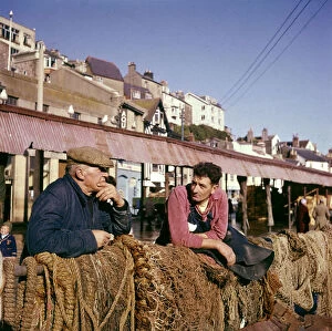 Nets Gallery: Two fishermen in Brixham Harbour, Devon