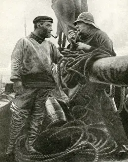 Two fishermen on a fishing smack, Suffolk, England