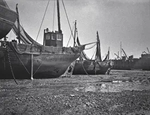 Cranes Prints: Fishing boats on a beach
