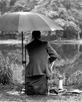 Images Dated 31st August 2016: Fishing in the rain Wanstead Park, East London