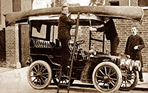 Fixing a canoe to the top of a veteran car, early 1900s