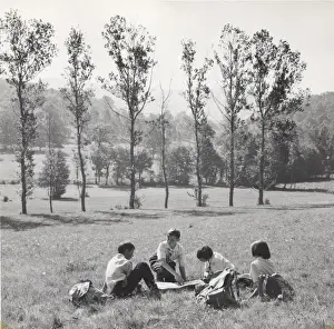 Intermediate Prints: French cub scouts, three boys and a girl, in a field