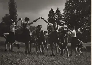 French cub scouts dancing in a field