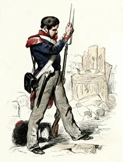 French National Guard soldier cleaning his rifle
